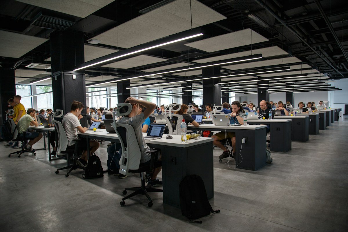 Investigative journalism desk with dual monitors analyzing cybersecurity breach reports