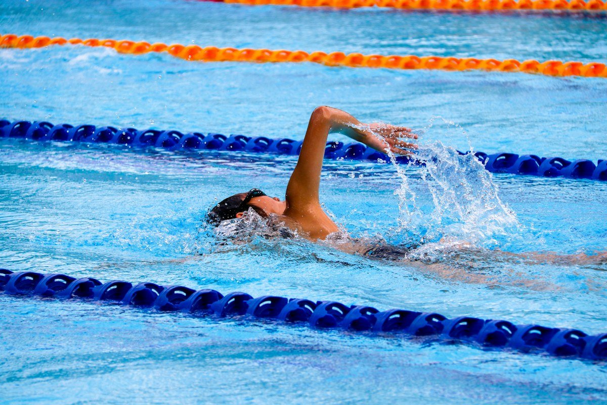 Prishtina Swimming Championships swimmers racing lane by lane in Olympic indoor pool